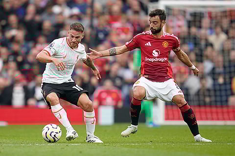 English Premier League 2024-25 Liverpool vs Manchester United: Liverpool's Alexis Mac Allister, left, challenges for the ball with Manchester United's Bruno Fernandes